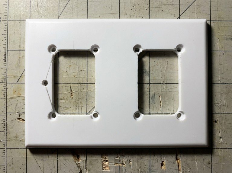 Cut HDPE edge examined under oblique light showing stress whitening on one section